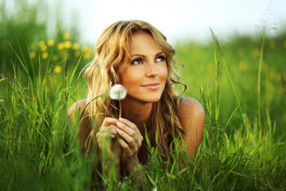 woman in grass dandylion