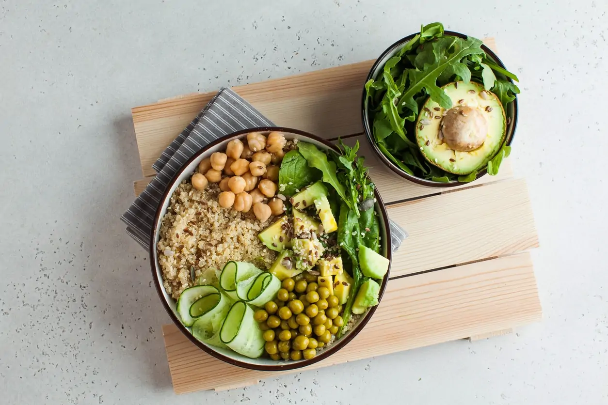 Healthy vegetable bowl with quinoa, avocado, chickpeas, and cucumber