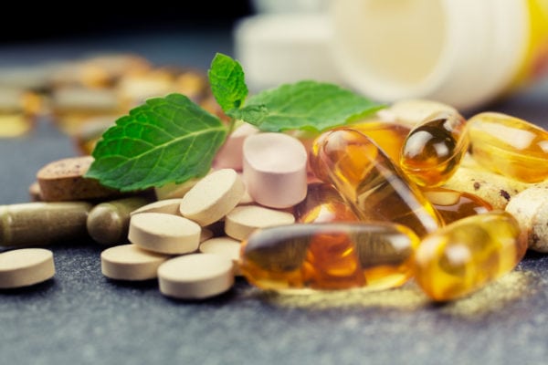 Assortment of supplements and a sprig of mint