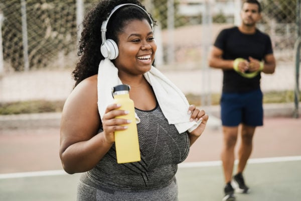 Woman doing morning workout routine outdoors at city park