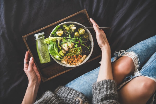 Healthy vegan bowl, smoothie and woman in jeans