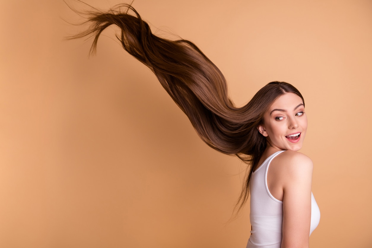 Portrait of young woman with very long healthy brown hair