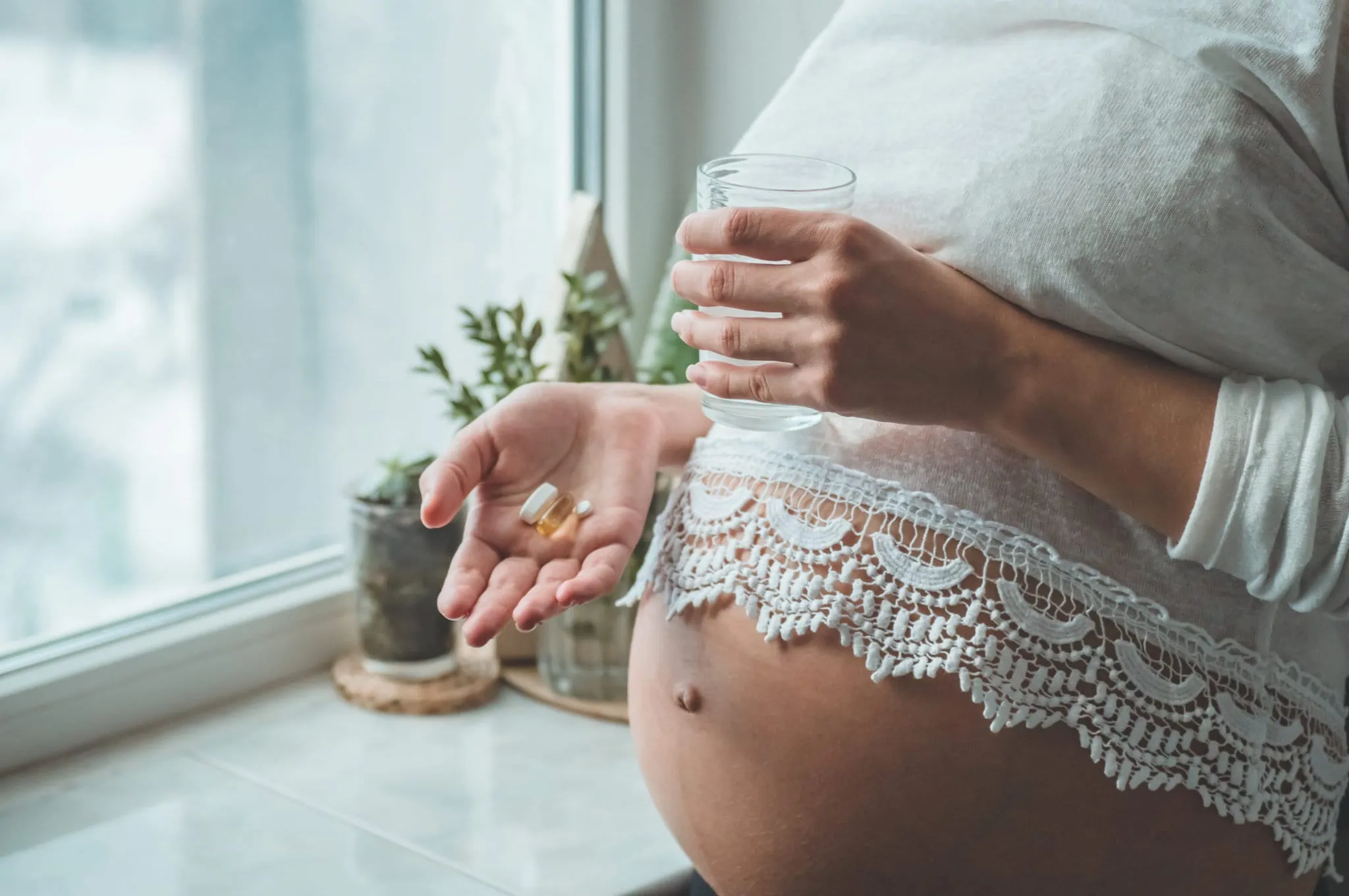 Pregnant woman taking pills during pregnancy. Last months of pregnancy.