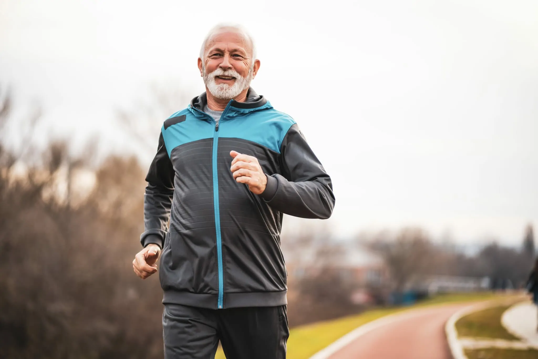 Active senior man is jogging.